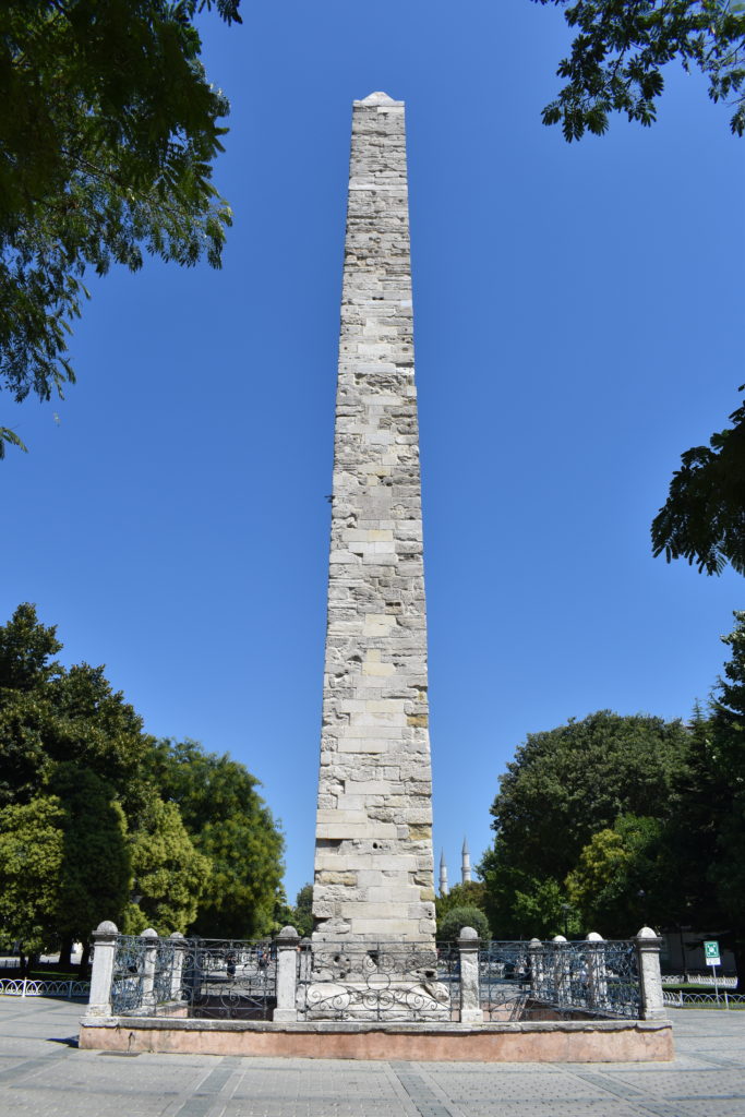 a tall stone tower in a park