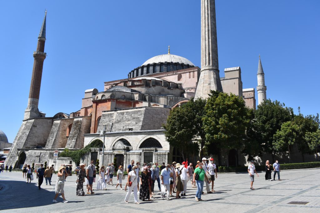a group of people in front of a large building with Hagia Sophia in the background