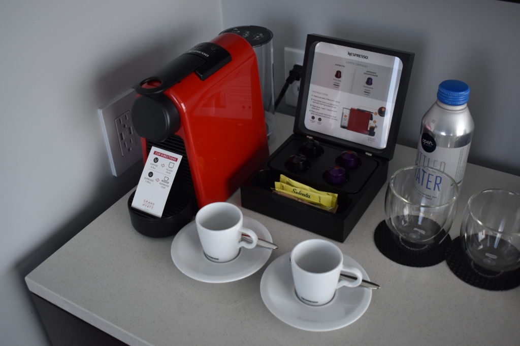 a coffee machine and cups on a table