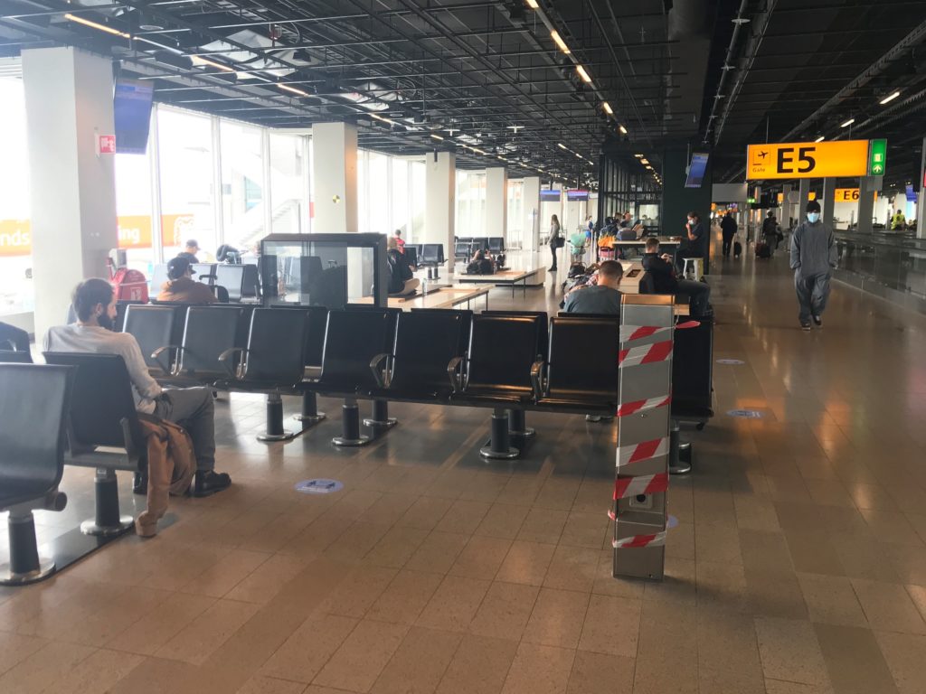 people sitting in chairs in an airport