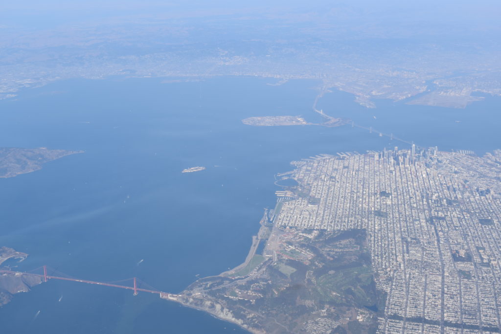 an aerial view of a city and a body of water