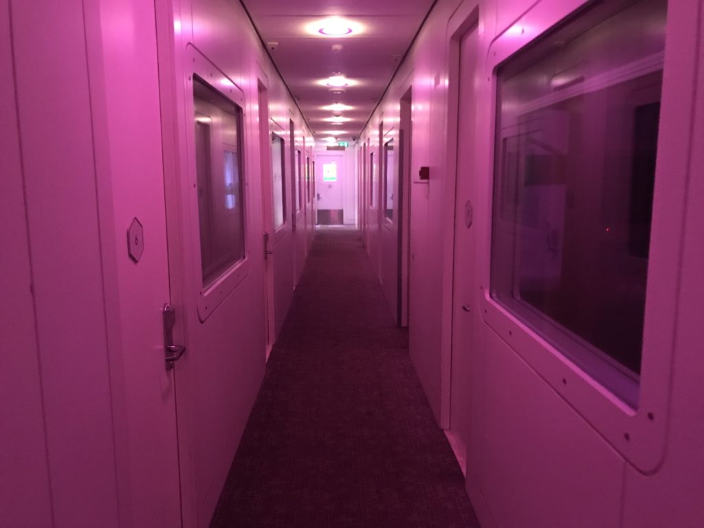 a long hallway with pink walls