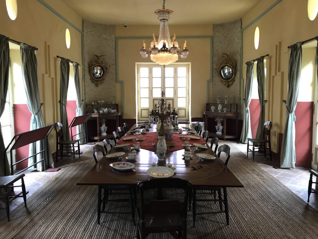 a large dining room with a chandelier and table