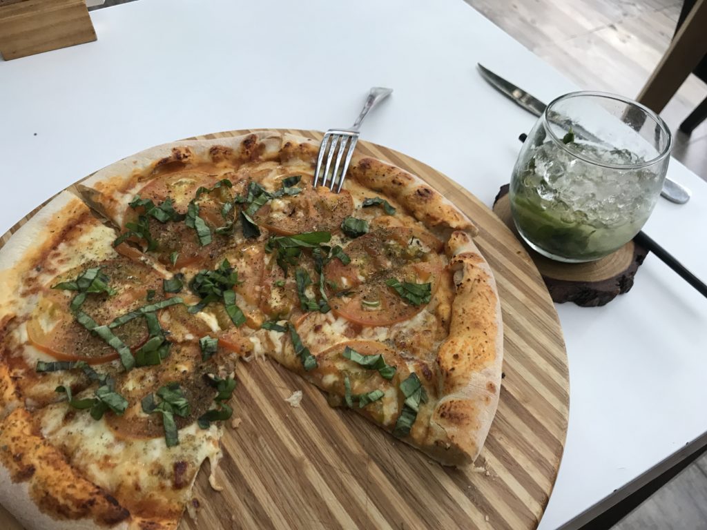 a pizza with a fork on a wooden board