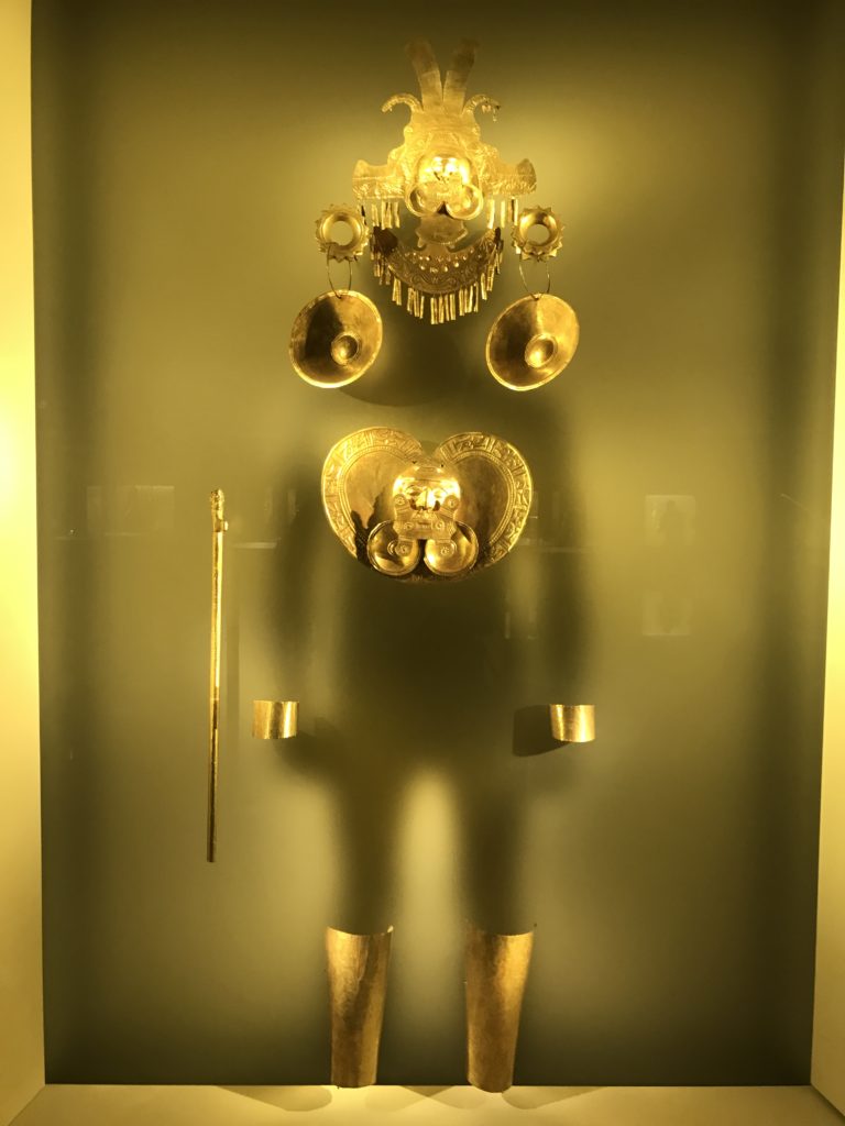 a gold object in a glass case