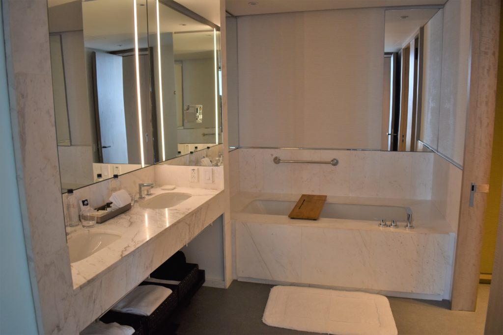 a bathroom with a large mirror and a bathtub