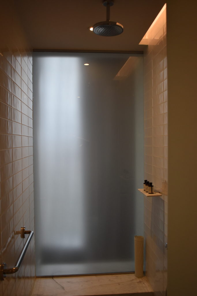 a shower with a frosted glass door