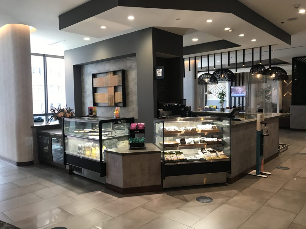 a coffee shop with a counter and a glass display case