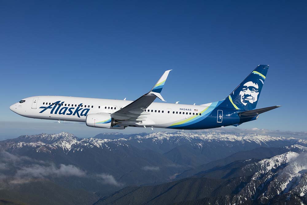 a plane flying over mountains