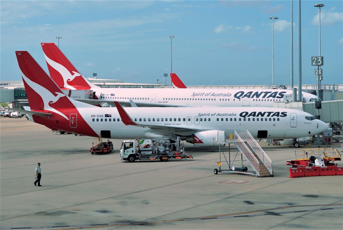 a group of airplanes parked at an airport