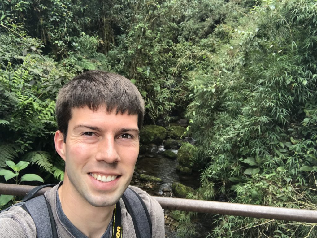 a man taking a selfie in a forest