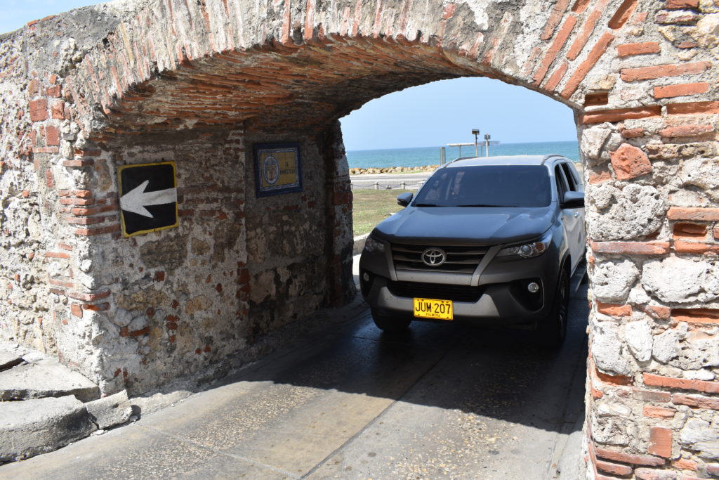 a car parked under a stone arch