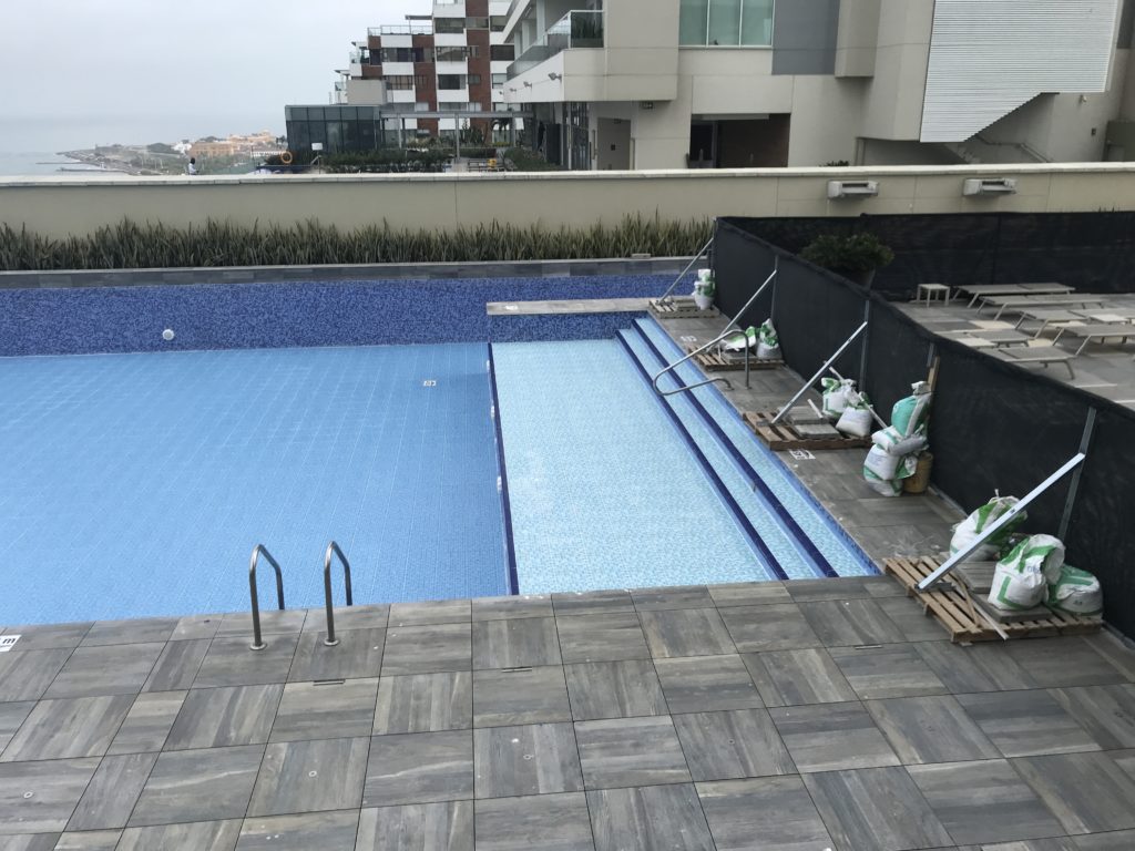 a swimming pool with a fence and a building
