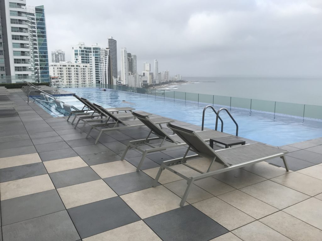 a pool with a view of a city and buildings