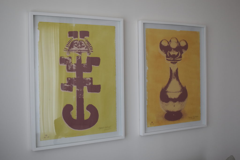 two framed art on a wall