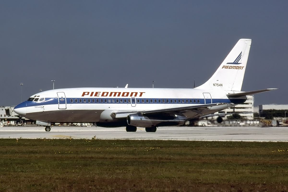 a white and blue airplane on a runway