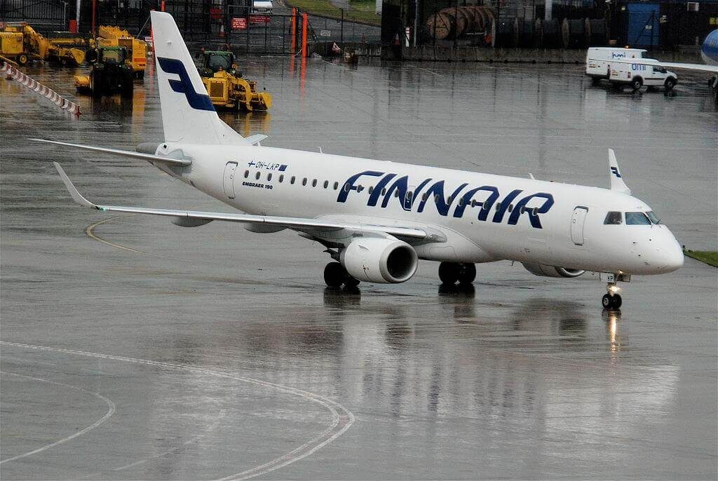 a white airplane on a wet runway