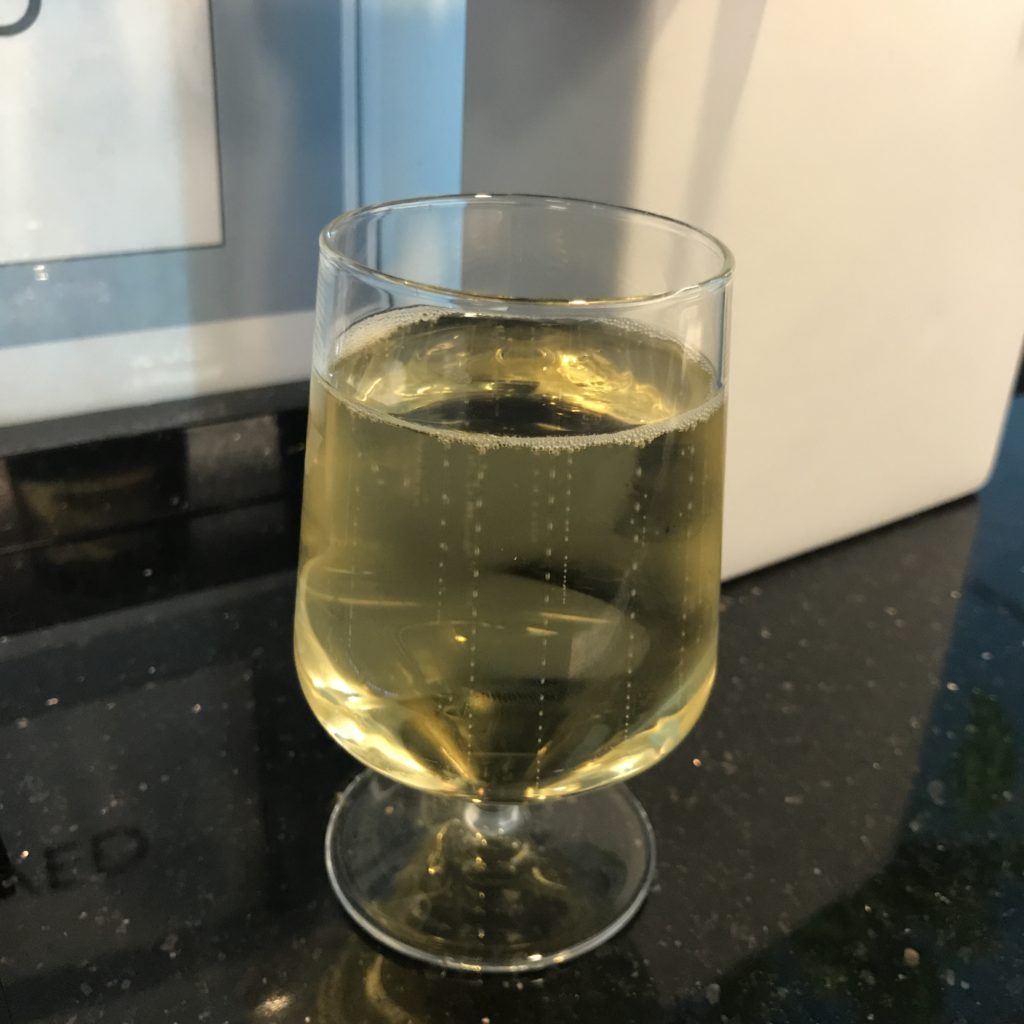 a glass of yellow liquid