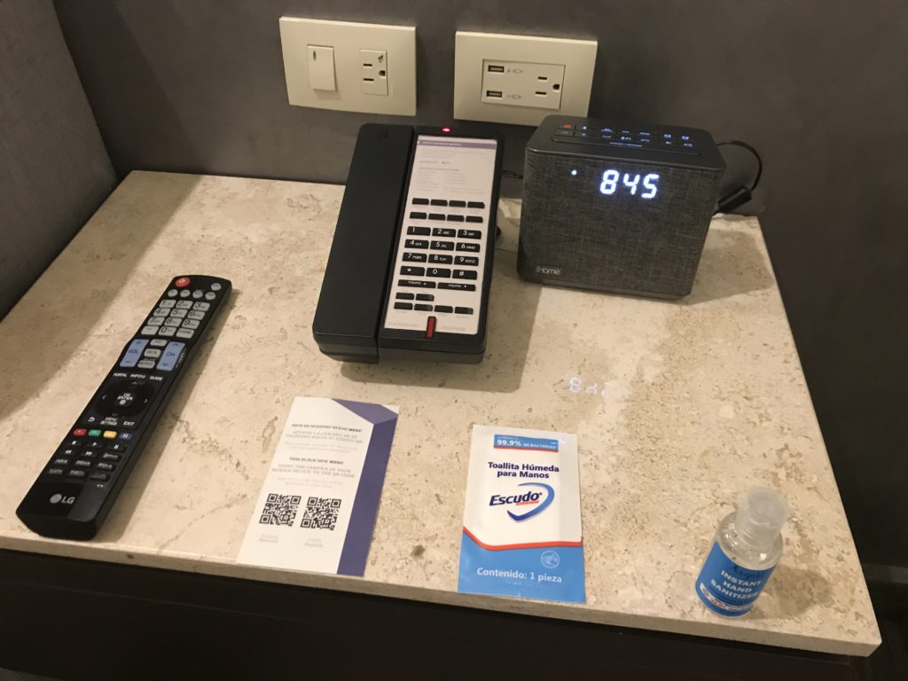 a phone and alarm clock on a counter