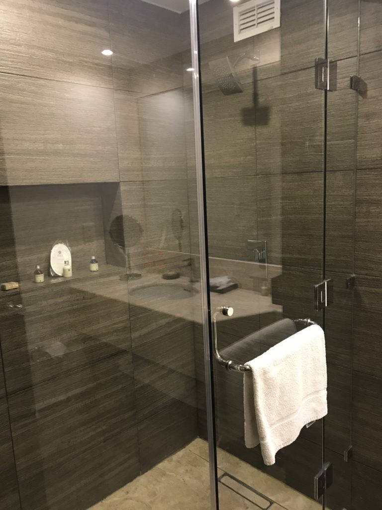 a glass shower door with a towel on the door