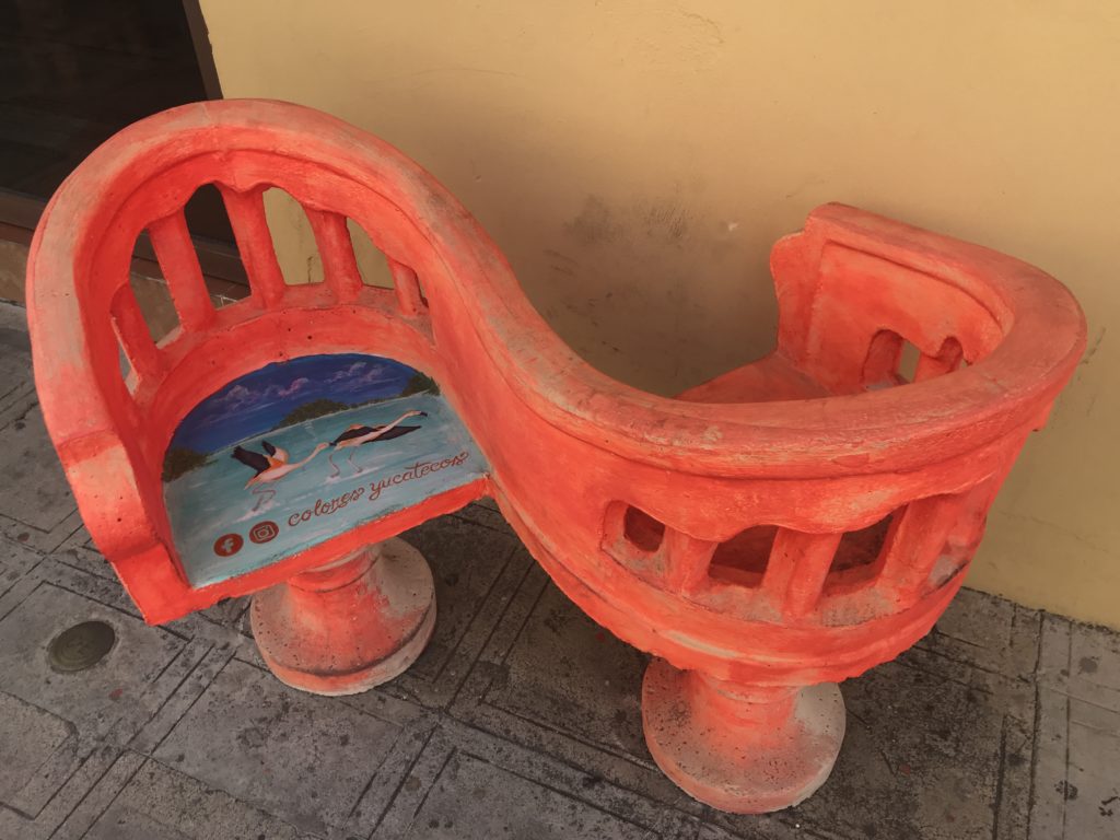 a red bench with a picture on it