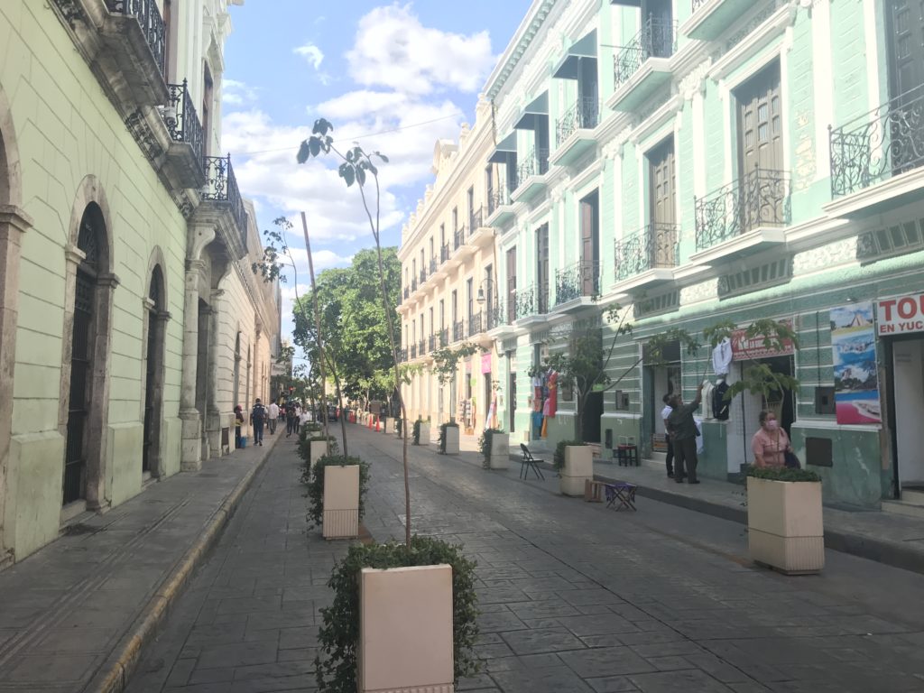 a street with buildings and people walking