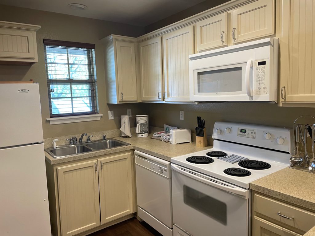 a kitchen with white appliances and cabinets