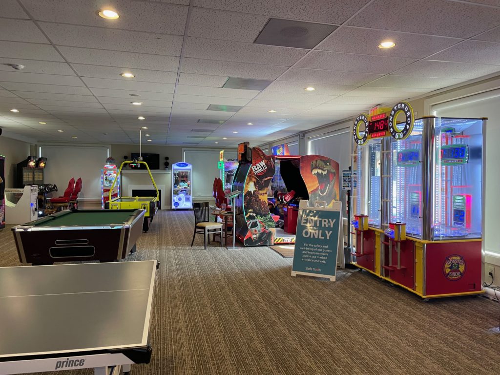 a room with a game room and arcade games