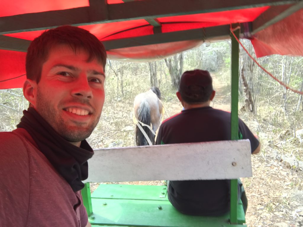 a man taking a selfie in a cart with two men