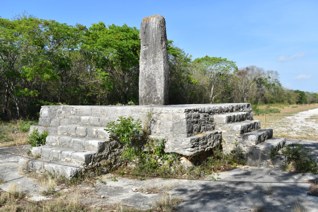 a stone structure with stairs and a pillar