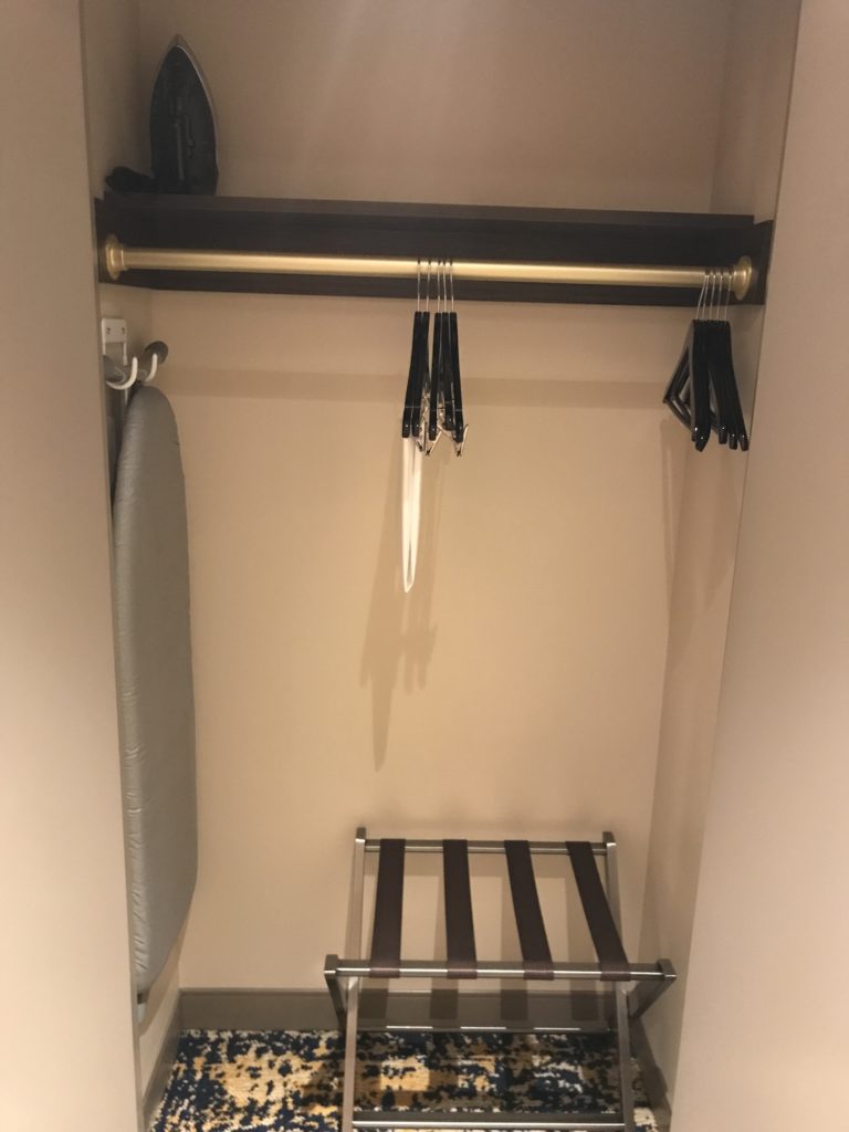 a closet with swingers and a rack