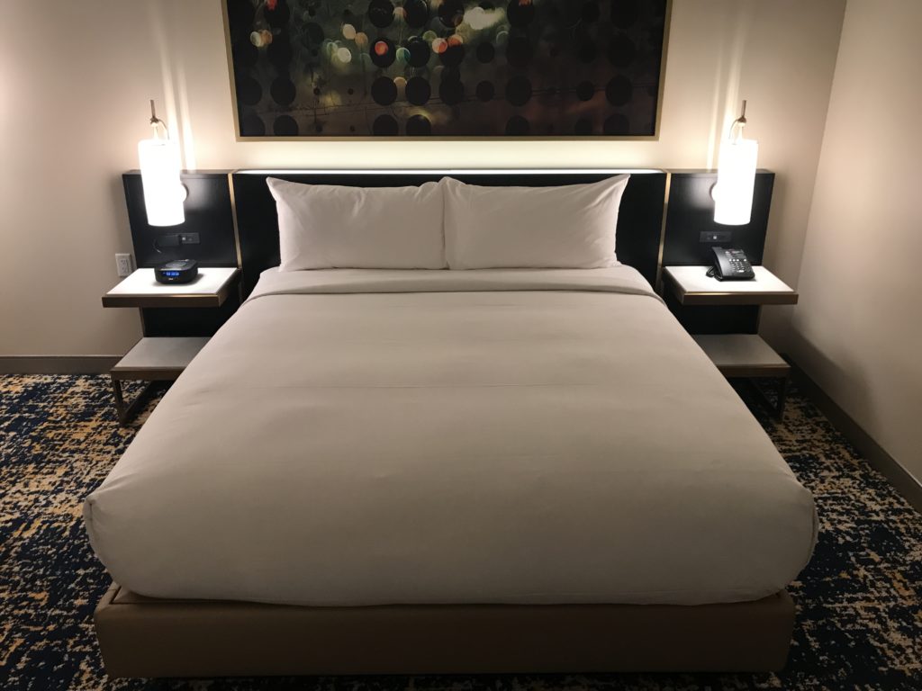 a bed with two lamps