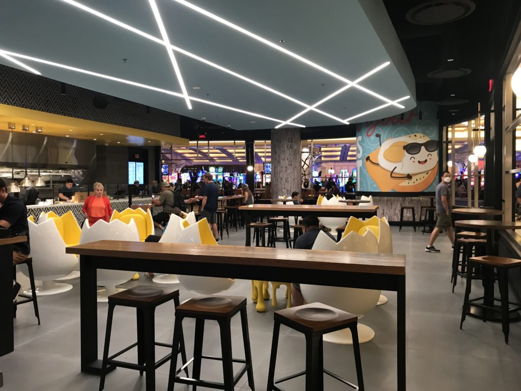 a group of people sitting at tables in a restaurant