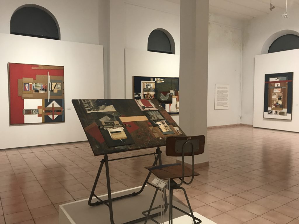 a art gallery with a chair and a table