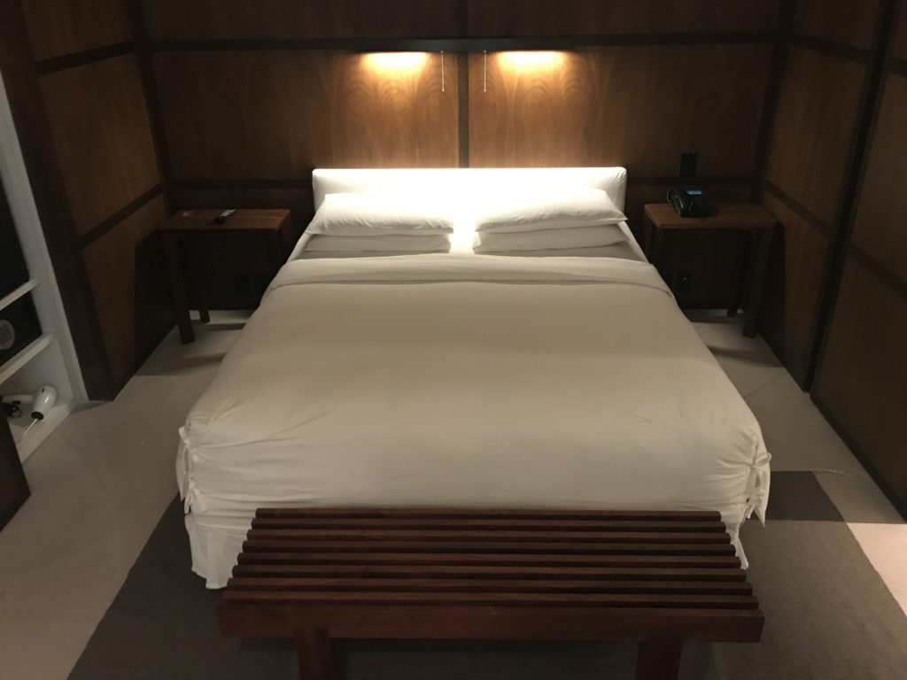 a bed with a light on the headboard
