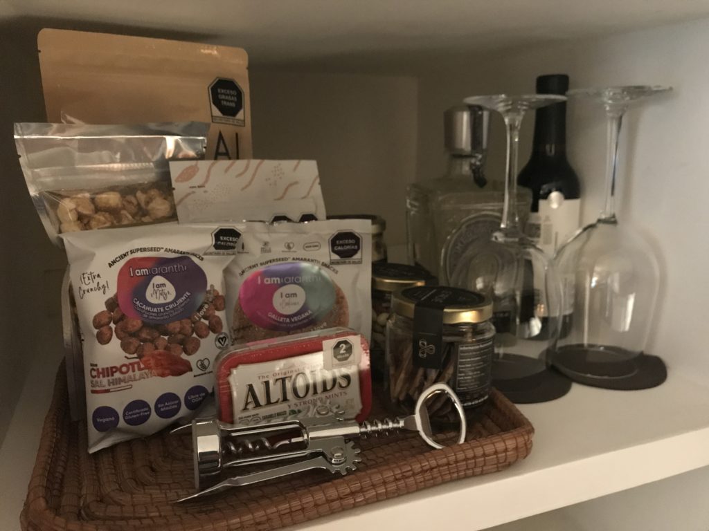 a shelf with food items and glasses