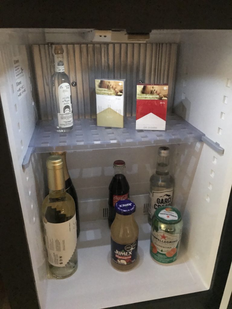 a small refrigerator with bottles of alcohol