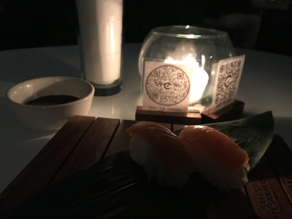 a plate of sushi and a candle