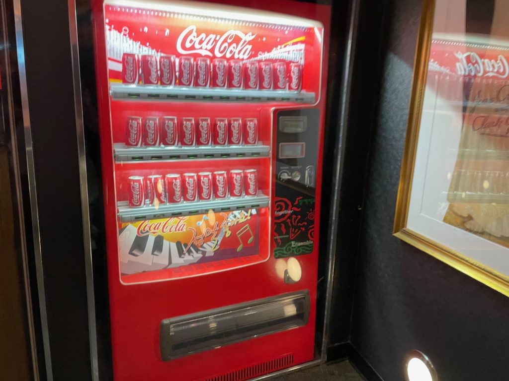 a vending machine with cans of soda