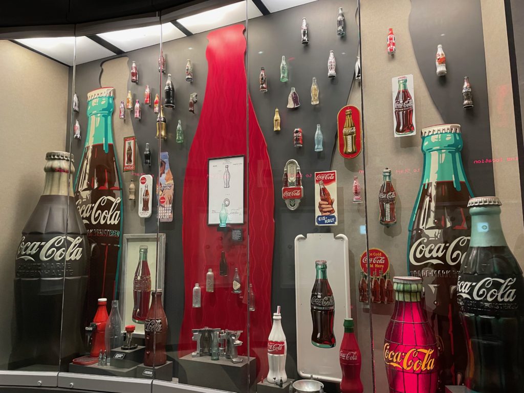 a display of a glass wall with a group of soda bottles