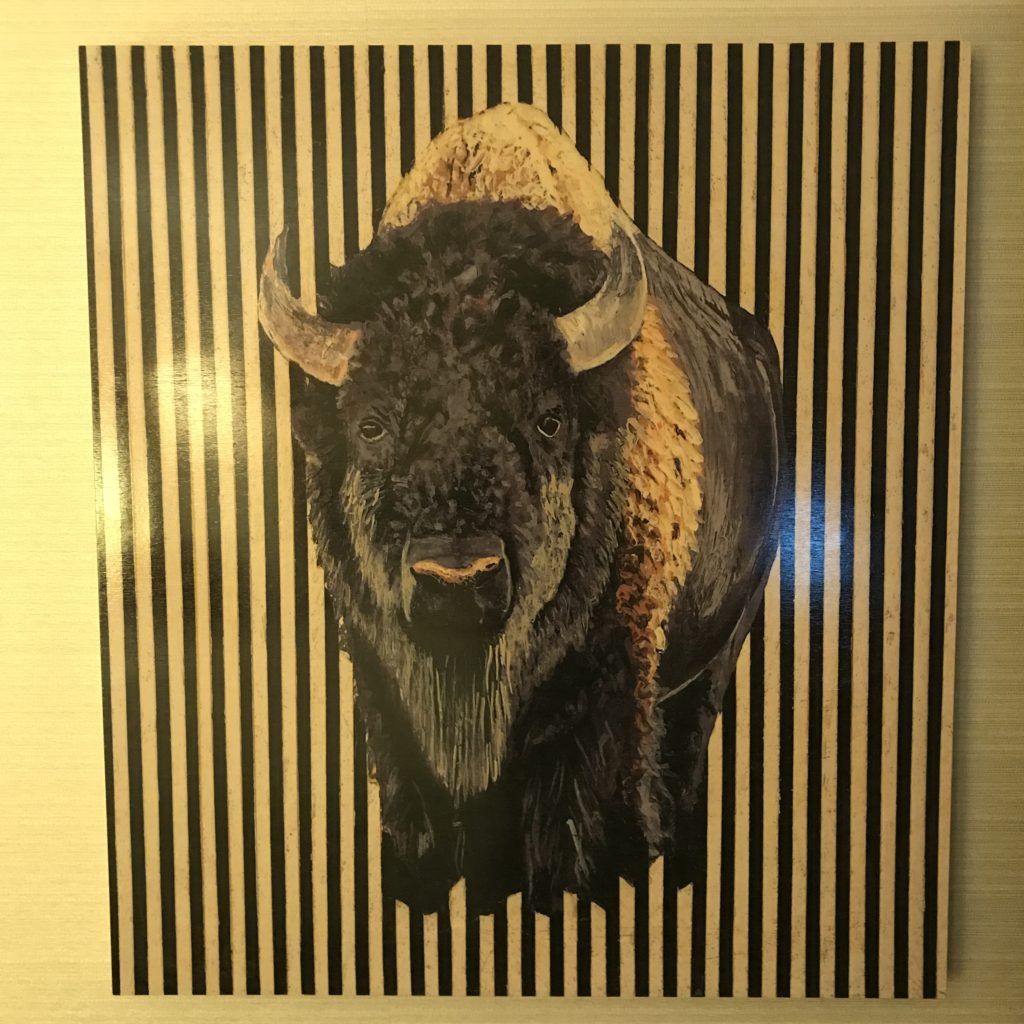 a painting of a buffalo on a wall