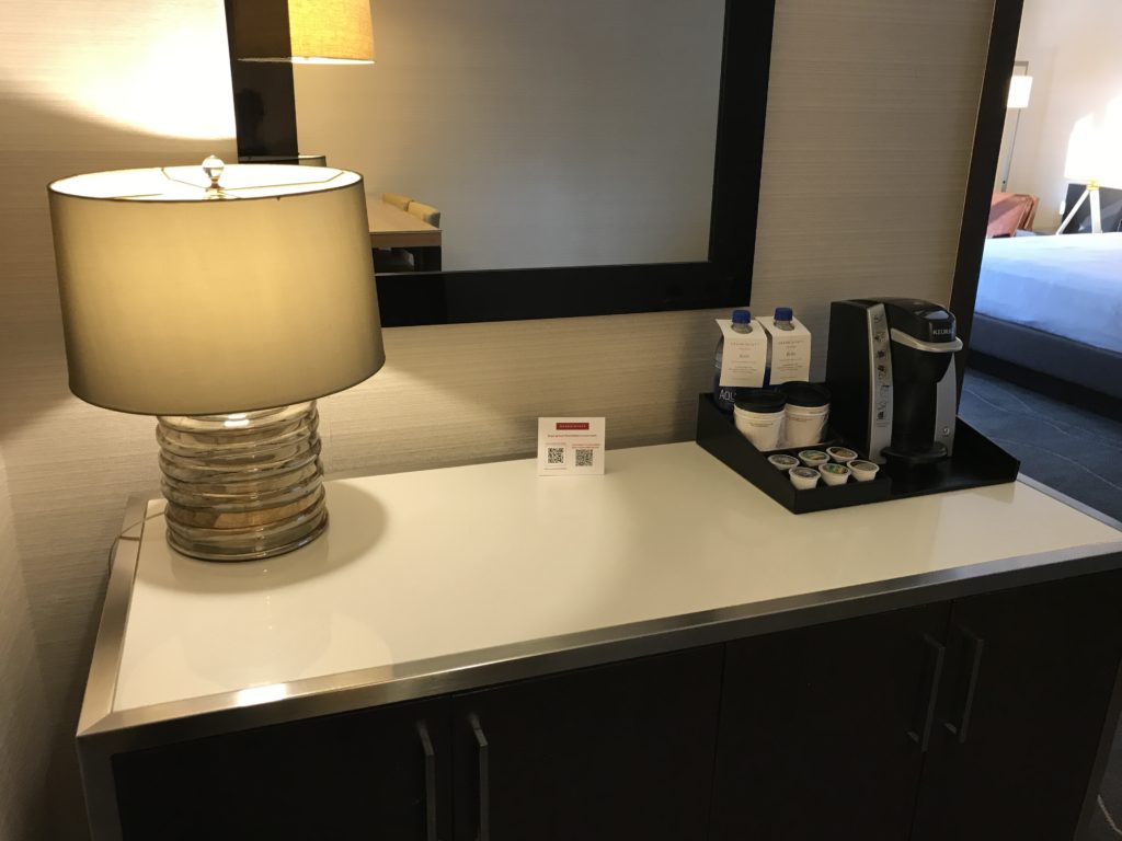 a table with a lamp and coffee cups on it