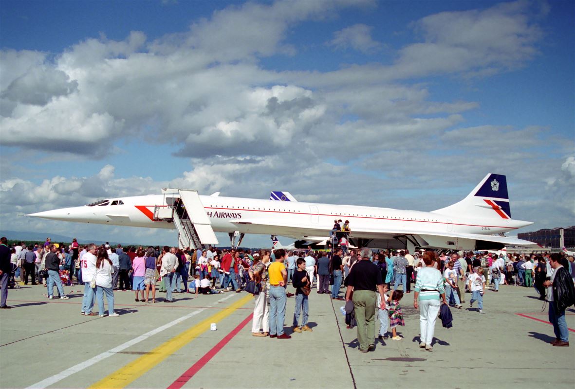 a group of people standing around an airplane