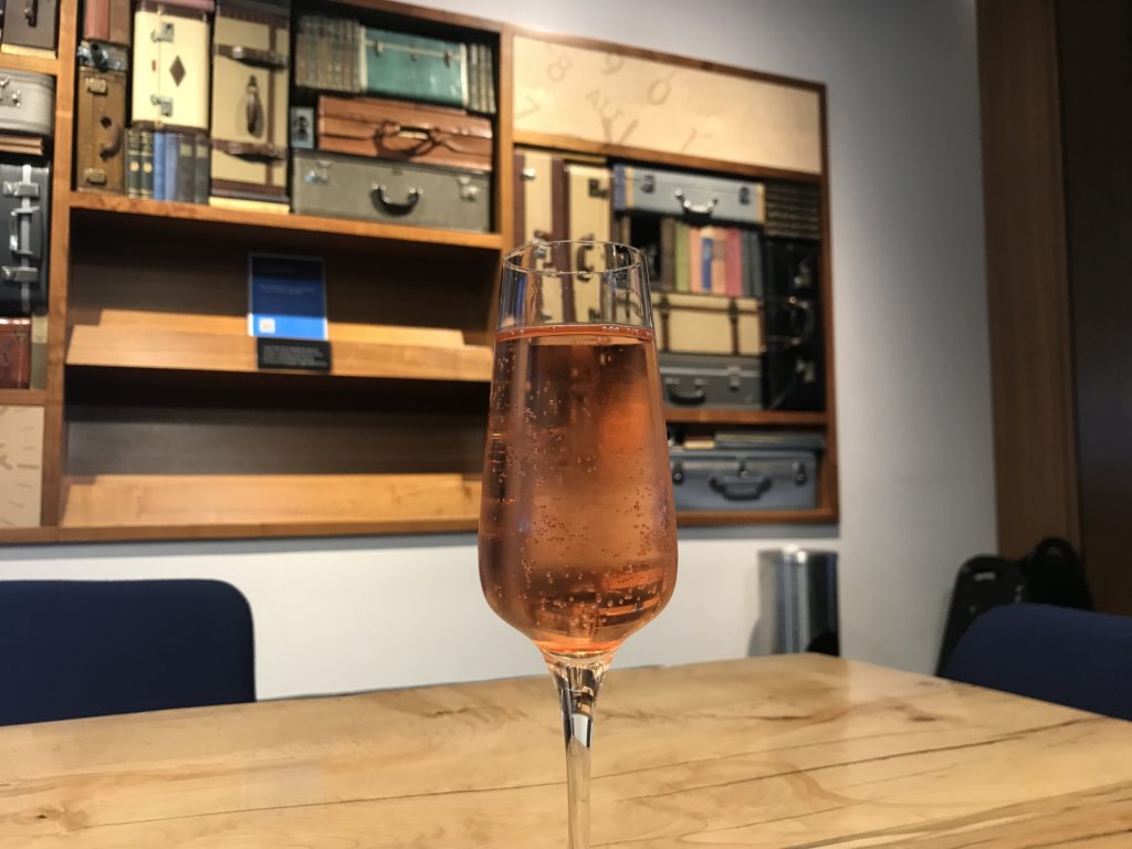 a glass of pink liquid on a table