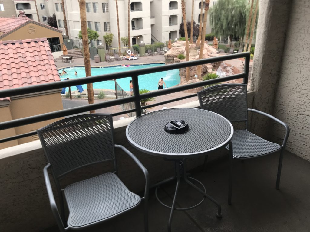 a table and chairs on a balcony