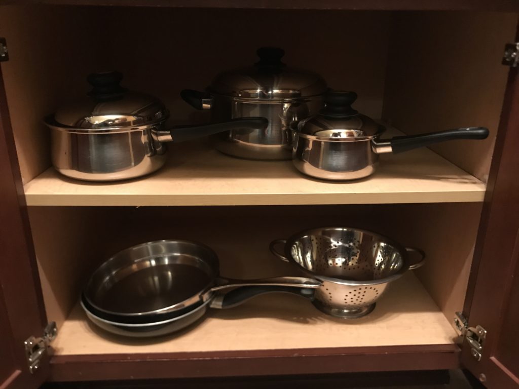 a group of pots and pans on shelves
