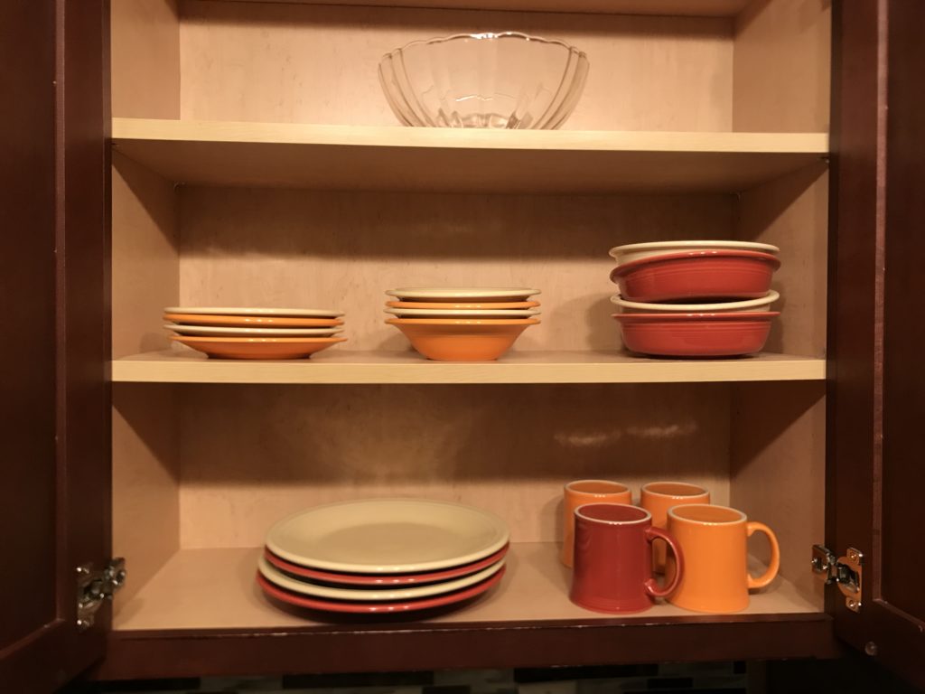 a shelf with plates and cups