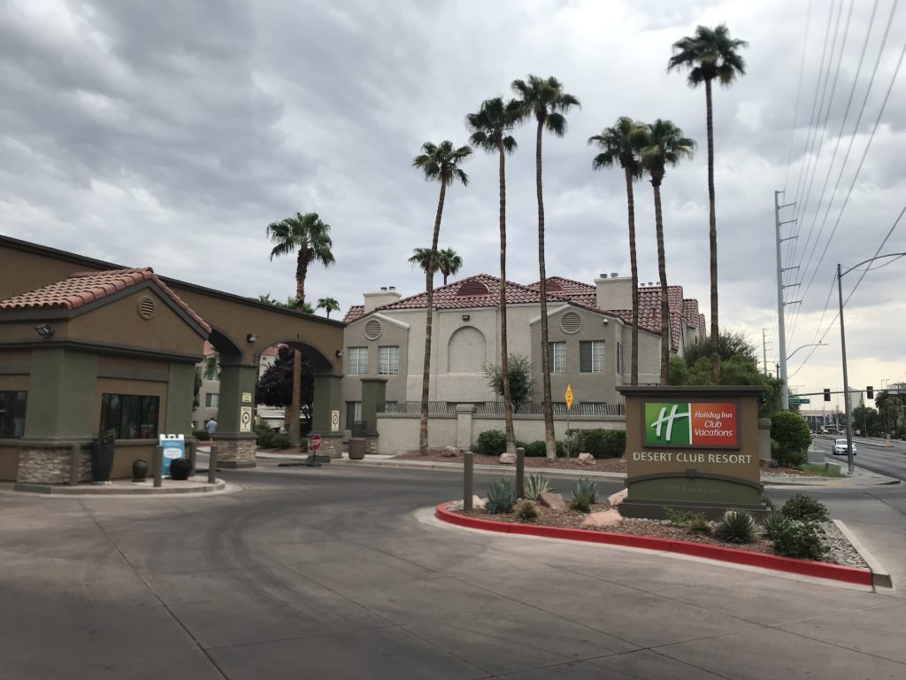 a street with palm trees and buildings