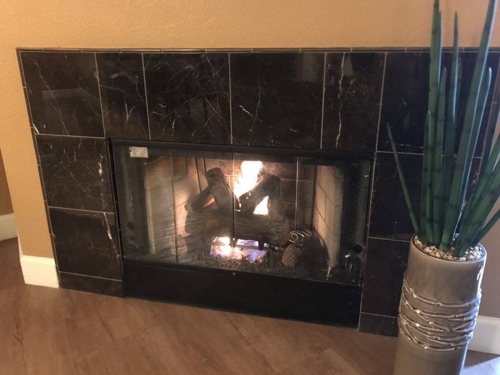 a fireplace with a wood burning inside