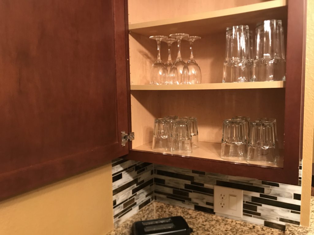 glasses on a shelf in a kitchen